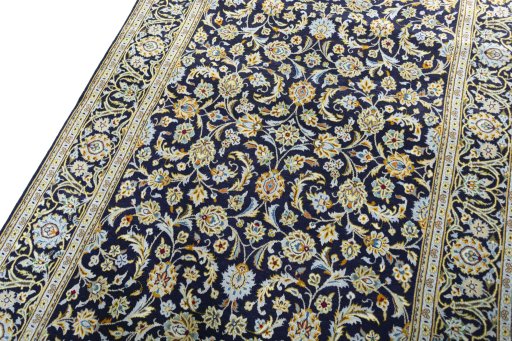 Backside of handmade 1970s Kashan rug showing knot structure and weave density