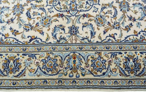 Corner detail of 2000s Kashan rug showing border pattern and Wool pile
