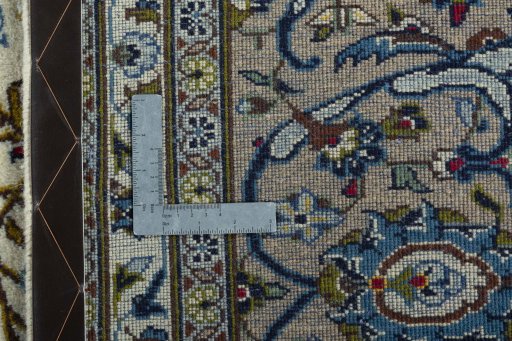 Backside of handmade 2000s Kashan rug showing knot structure and weave density