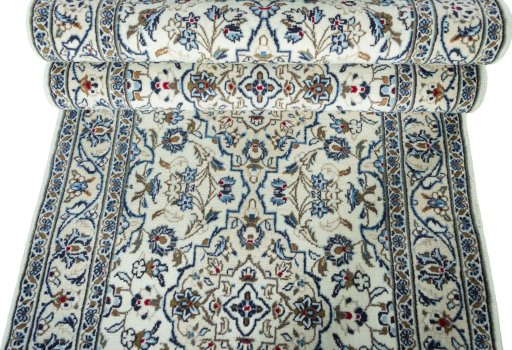 Corner detail of New Kashan rug showing border pattern and Wool pile