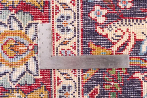 Corner detail of 2000s Kashan rug showing border pattern and Wool pile