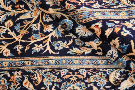 Corner detail of 1970s Kashan rug showing border pattern and Wool pile