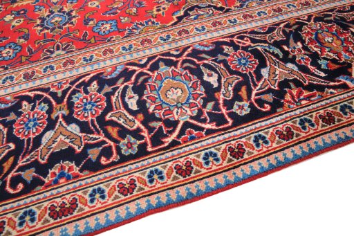 Backside of handmade 2000s Kashan rug showing knot structure and weave density