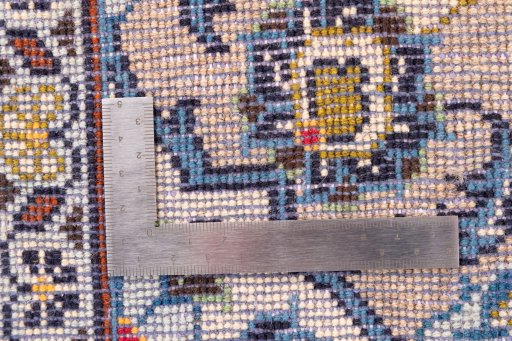 Corner detail of 2000s Kashan rug showing border pattern and Wool pile