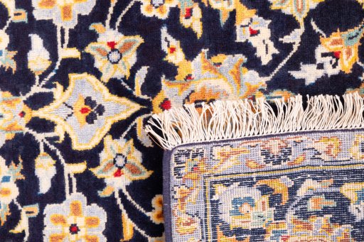 Close-up detail of 1975s Kashan rug from Iran / Persia showing Wool weave