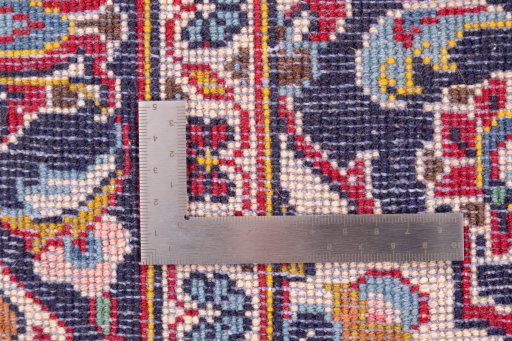 Corner detail of 2000s Kashan rug showing border pattern and Wool pile