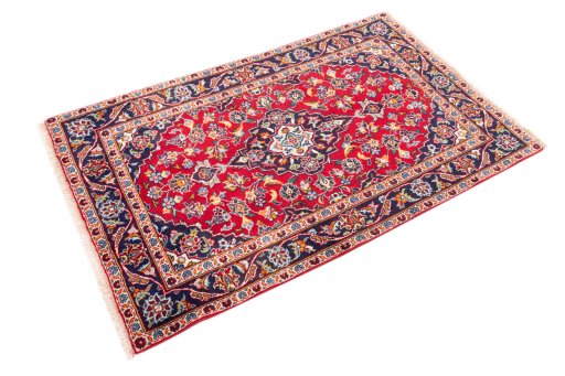 Corner detail of 2000s Kashan rug showing border pattern and Wool pile