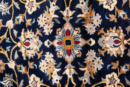 Corner detail of 2003s Kashan rug showing border pattern and Wool pile