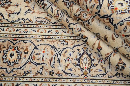 Corner detail of 2000s Kashan rug showing border pattern and Wool pile