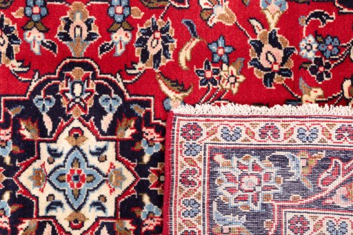 Close-up detail of 1996s Kashan rug from Iran / Persia showing Wool weave