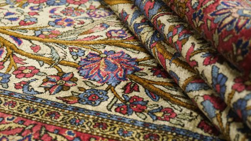 Corner detail of 1920s Kashan rug showing border pattern and Silk pile
