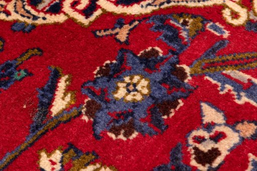 Backside of handmade 1990s Kashan rug showing knot structure and weave density