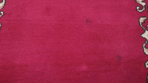 Corner detail of 2000s Kashan rug showing border pattern and Wool pile