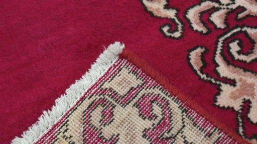 Close-up detail of 2000s Kashan rug from Iran / Persia showing Wool weave
