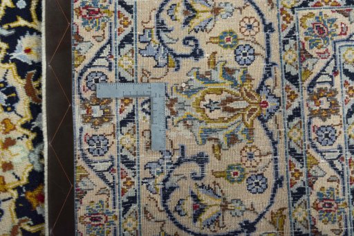 Backside of handmade 2000s Kashmar rug showing knot structure and weave density