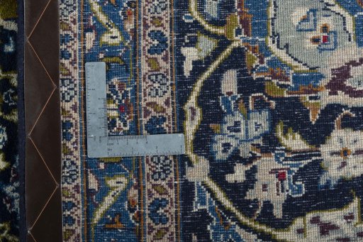 Backside of handmade 2000s Kashmar rug showing knot structure and weave density