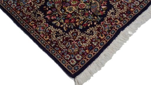 Surface texture of 1980s Kerman rug with natural Wool and intricate pattern