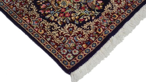 Surface texture of 1970s Kerman rug with natural Wool and intricate pattern