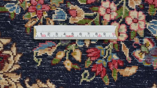 Backside of handmade 1970s Kerman rug showing knot structure and weave density