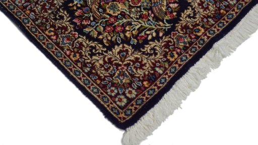 Surface texture of 1970s Kerman rug with natural Wool and intricate pattern