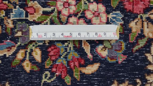Backside of handmade 1970s Kerman rug showing knot structure and weave density