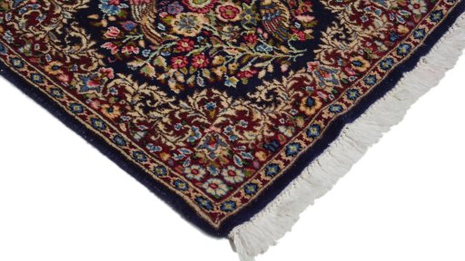 Surface texture of 1970s Kerman rug with natural Wool and intricate pattern