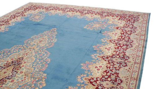 Surface texture of 1960s Kerman rug with natural Wool and intricate pattern