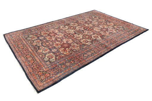 Corner detail of 1900s Kerman rug showing border pattern and Wool pile