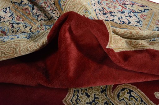 Surface texture of 2000s Kerman rug with natural Wool and intricate pattern