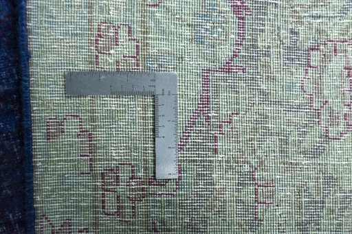 Backside of handmade 1970s Kerman rug showing knot structure and weave density