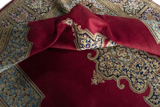 Surface texture of 2000s Kerman rug with natural Wool and intricate pattern