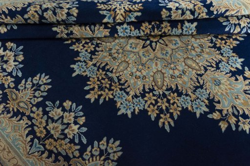 Close-up detail of 2000s Kerman rug from Iran / Persia showing Wool weave