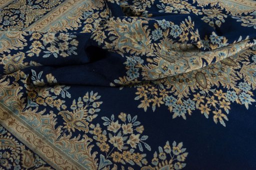 Surface texture of 2000s Kerman rug with natural Wool and intricate pattern