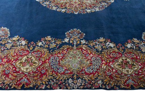 Corner detail of 1970s Kerman rug showing border pattern and Wool pile