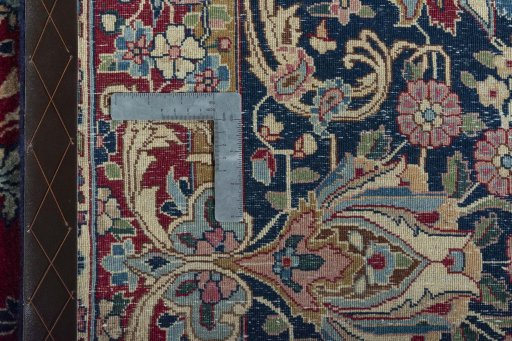 Backside of handmade 1950s Kerman rug showing knot structure and weave density