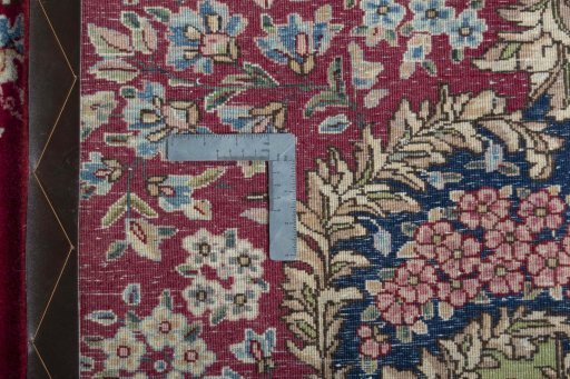 Backside of handmade 1970s Kerman rug showing knot structure and weave density