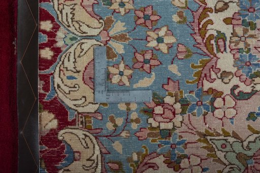 Backside of handmade 2000s Kerman rug showing knot structure and weave density