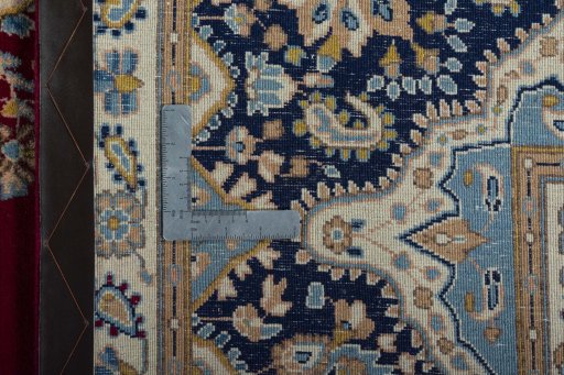 Backside of handmade 2000s Kerman rug showing knot structure and weave density