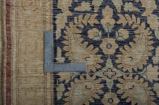 Backside of handmade 1950s Kerman rug showing knot structure and weave density
