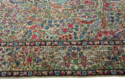 Corner detail of 2000s Kerman rug showing border pattern and Wool pile