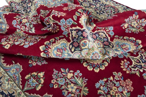 Surface texture of 2000s Kerman rug with natural Wool and intricate pattern