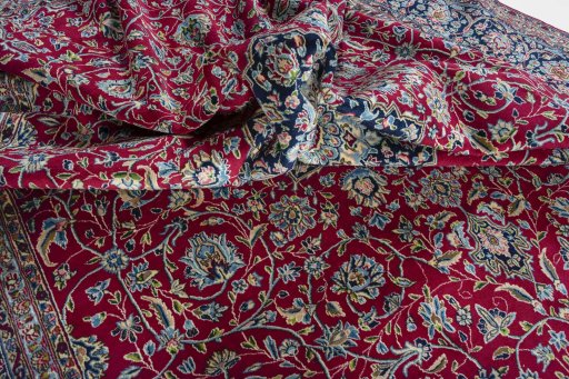 Surface texture of 2000s Kerman rug with natural Wool and intricate pattern