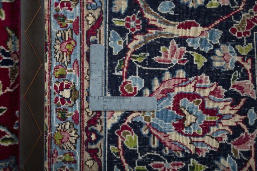 Backside of handmade 2000s Kerman rug showing knot structure and weave density