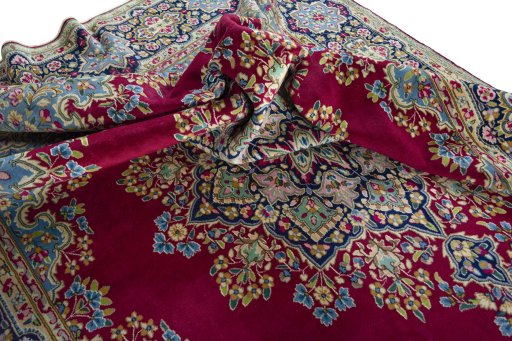 Surface texture of 1970s Kerman rug with natural Wool and intricate pattern