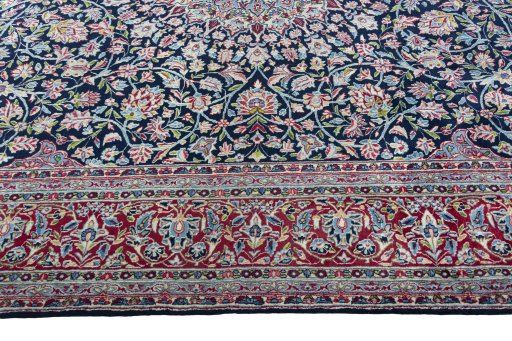 Corner detail of 2000s Kerman rug showing border pattern and Wool pile