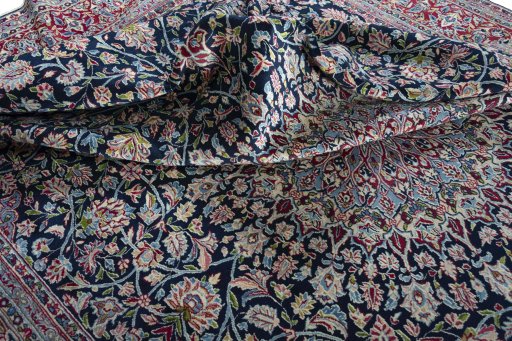 Surface texture of 2000s Kerman rug with natural Wool and intricate pattern