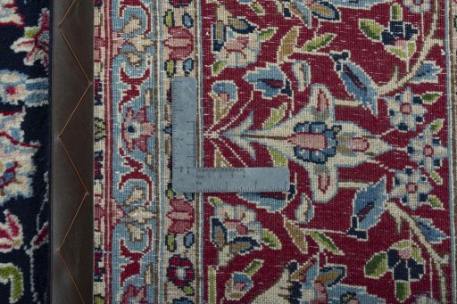 Backside of handmade 2000s Kerman rug showing knot structure and weave density