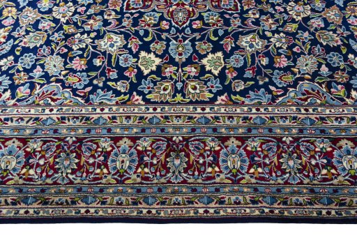 Corner detail of 2000s Kerman rug showing border pattern and Wool pile