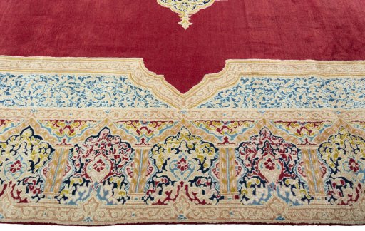 Corner detail of 2000s Kerman rug showing border pattern and Wool pile