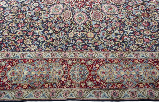 Corner detail of 2000s Kerman rug showing border pattern and Wool pile